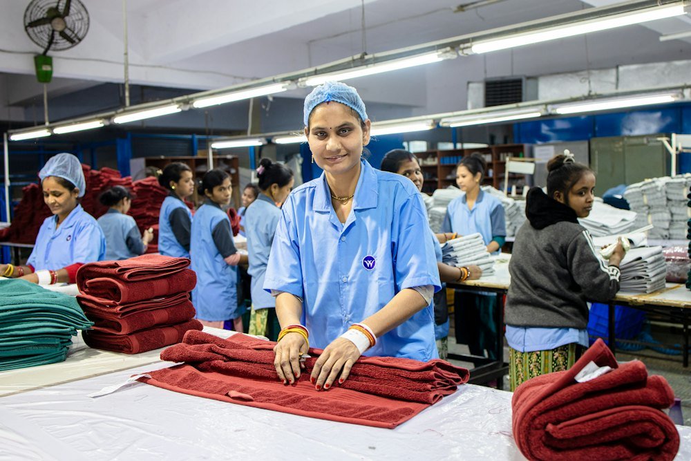 Workers folding finished fabric